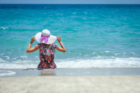 Happy girl on the shore of the sea in travel vacationの写真素材