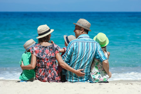 Happy family with children on the coast of the sea travelの写真素材