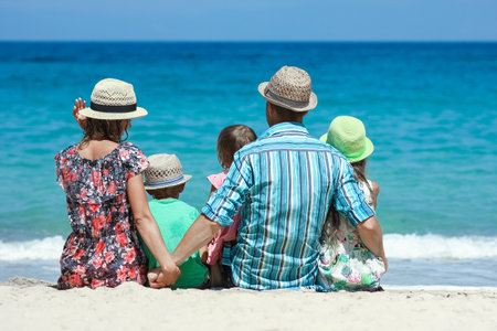Happy family with children on the coast of the sea travelの写真素材