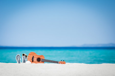 beautiful guitar on the sand by the Greek seaの写真素材