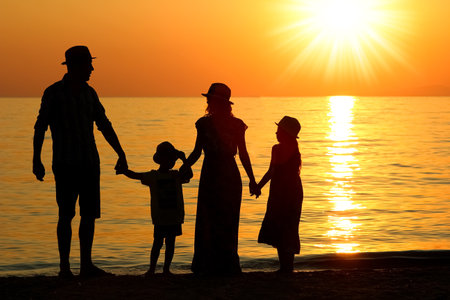 happy family by the sea in nature silhouette weekend travelの写真素材