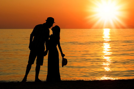 happy couple by the sea in nature silhouette weekend travelの写真素材