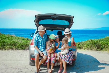 happy family by car by the sea in nature weekend travelの写真素材