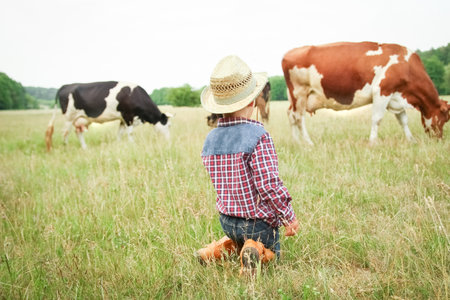 happy baby cowboy in natureの写真素材