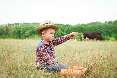 happy baby cowboy in natureの写真素材