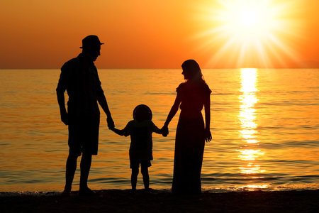 happy family by the sea in nature silhouette weekend travelの写真素材