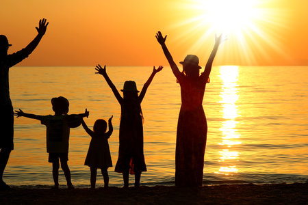 happy family by the sea in nature silhouette weekend travelの写真素材