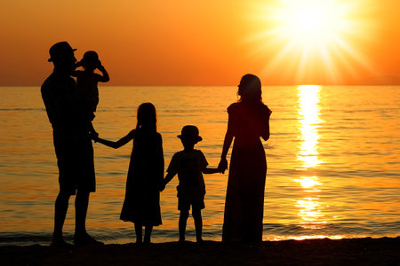 happy family by the sea in nature silhouette weekend travelの写真素材