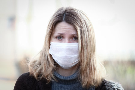 masked woman against kronavirus contaminated air protectionの写真素材