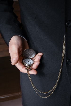 pocket watch in the hands of a manの写真素材