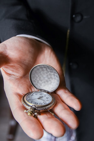 pocket watch in the hands of a manの写真素材