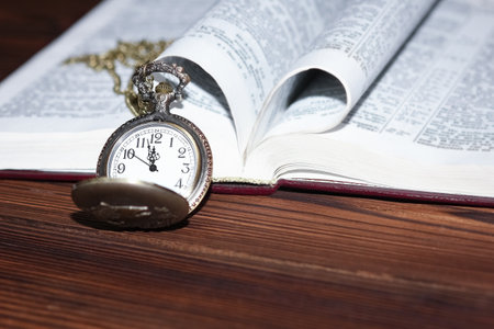 pocket watch with book backgroundの写真素材