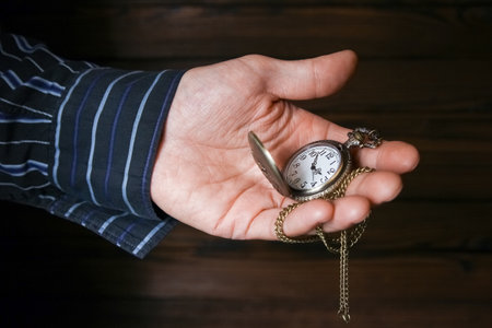 pocket watch in the hands of a manの写真素材