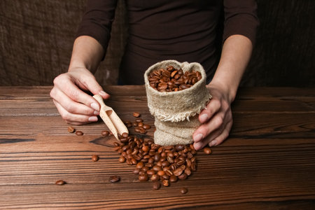 a female  hands and coffee grinderの写真素材