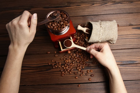 a female  hands and coffee grinderの写真素材