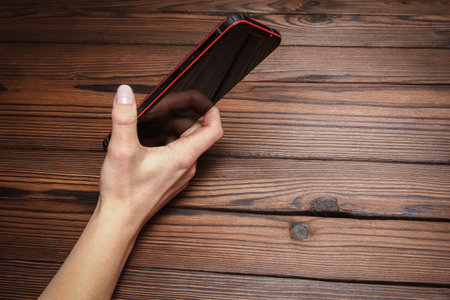 phone with hands addiction on a wooden backgroundの写真素材