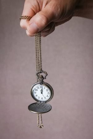 pocket watch in the hands of a manの写真素材