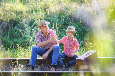 father and son cowboys concept happiness togetherの写真素材