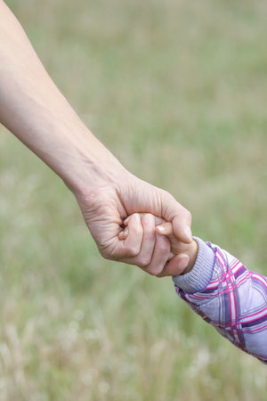 hands Happy parents and child outdoors in the parkの写真素材