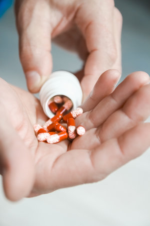 pills in the hands of the patient the concept of treatment and healthの写真素材