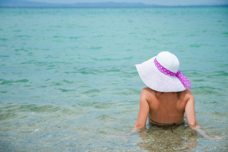 happy girl at sea in greece on sand natureの写真素材