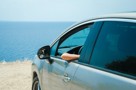 happy girl from car at sea greece backgroundの写真素材