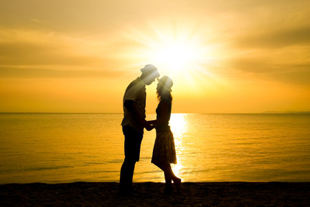 happy couple by the sea on nature in travel silhouetteの写真素材