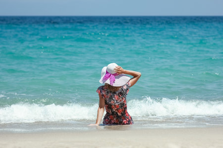 Happy girl on the shore of the sea in travel vacationの写真素材