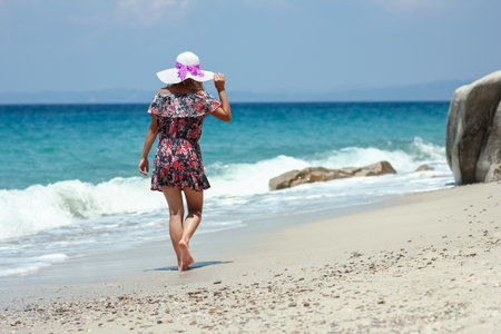 Happy girl on the shore of the sea in travel vacationの写真素材