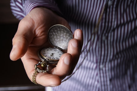 pocket watch in the hands of a manの写真素材