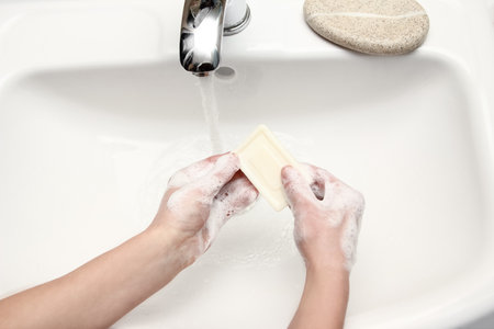 Hands with soap are washed under the tap with water. Clean from infection and dirt and virus. At home or in the hospital ablution office.の写真素材