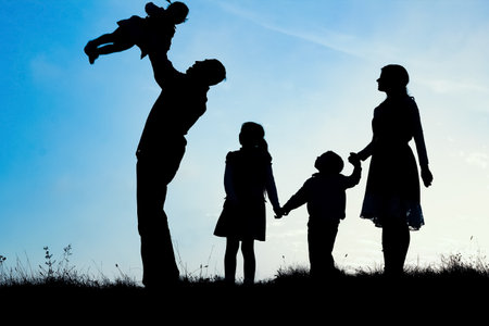 happy family by the sea on nature silhouette backgroundの写真素材