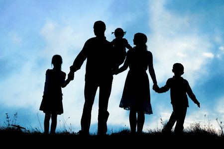 happy family by the sea on nature silhouette backgroundの写真素材