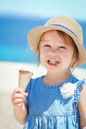 happy child with ice cream by the sea on weekend travel shoreの写真素材