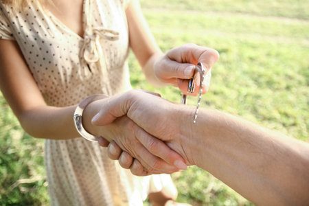 man handcuffed outdoors in the parkの写真素材