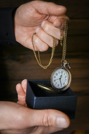 pocket watch in the hands of a manの写真素材