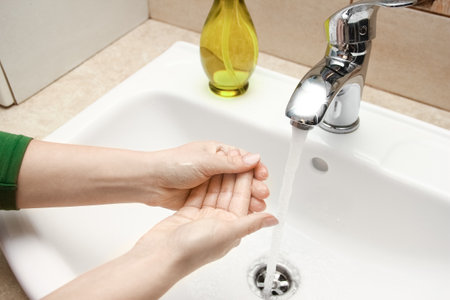 Hands with soap are washed under the tap with water. Clean from infection and dirt and virus. At home or in the hospital ablution office.の写真素材