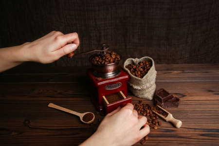 a female  hands and coffee grinderの写真素材