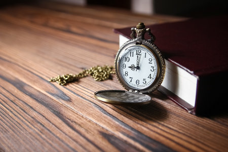 pocket watch with book backgroundの写真素材