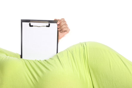 Happy pregnant girl lies on white backgroundの写真素材