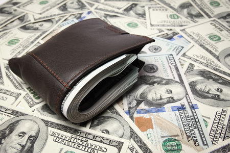 Money dollars in purse on money backgroundの写真素材