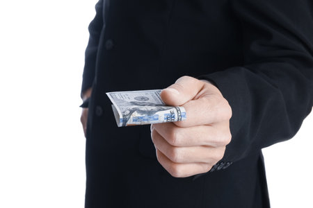 Business man holding money on white backgroundの写真素材