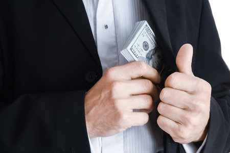 Business man holding money on white backgroundの写真素材