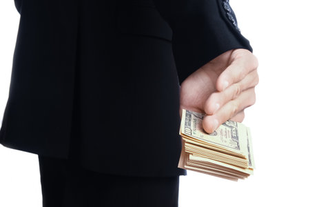 Business man holding money on white backgroundの写真素材