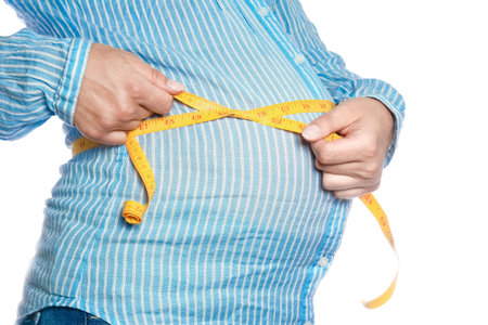 Happy pregnant girl lies on white backgroundの写真素材