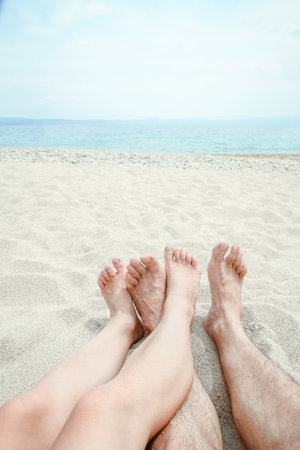 beautiful legs in the sand of the sea greece backgroundの写真素材