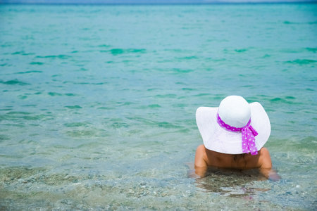 happy girl at sea in greece on sand natureの写真素材