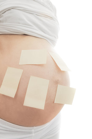 Pregnant girl on white background with stickersの写真素材