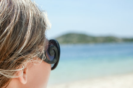 happy girl with sunglasses by the sea on nature backgroundの写真素材