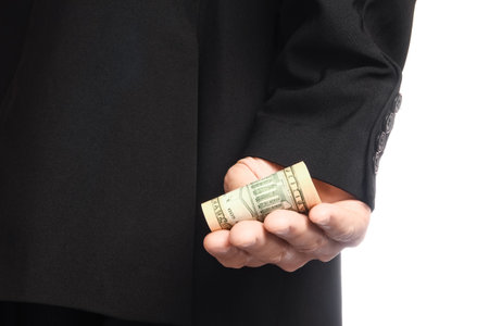 Business man holding money on white backgroundの写真素材